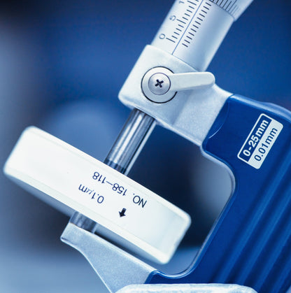 &lt;Laboratory micrometer for measuring thickness with blue handle, graduated brushed steel cylinder and adjustment dial, and calibration block. Credit&gt; AdobeStock_141253680 