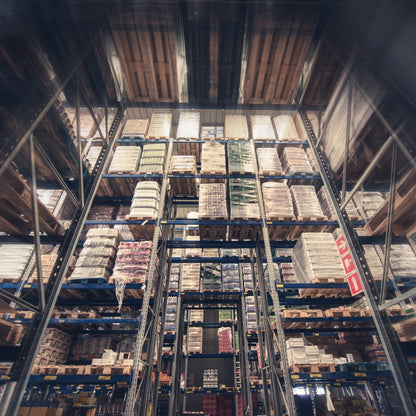 &lt;Close up of racking seven pallet spaces wide and seven spaces high containing trays of bottles with a gap in the middle forming a rectangular arch walkway. Credit&gt; AdobeStock_144478550