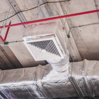 &lt;Fire spray and air handling system with white square grid outlet and ducts covered in silver lagging on the concrete ceiling of a dietary supplement facility to provide fire protection, clean air and ventilation. Credit&gt; AdobeStock_166402650