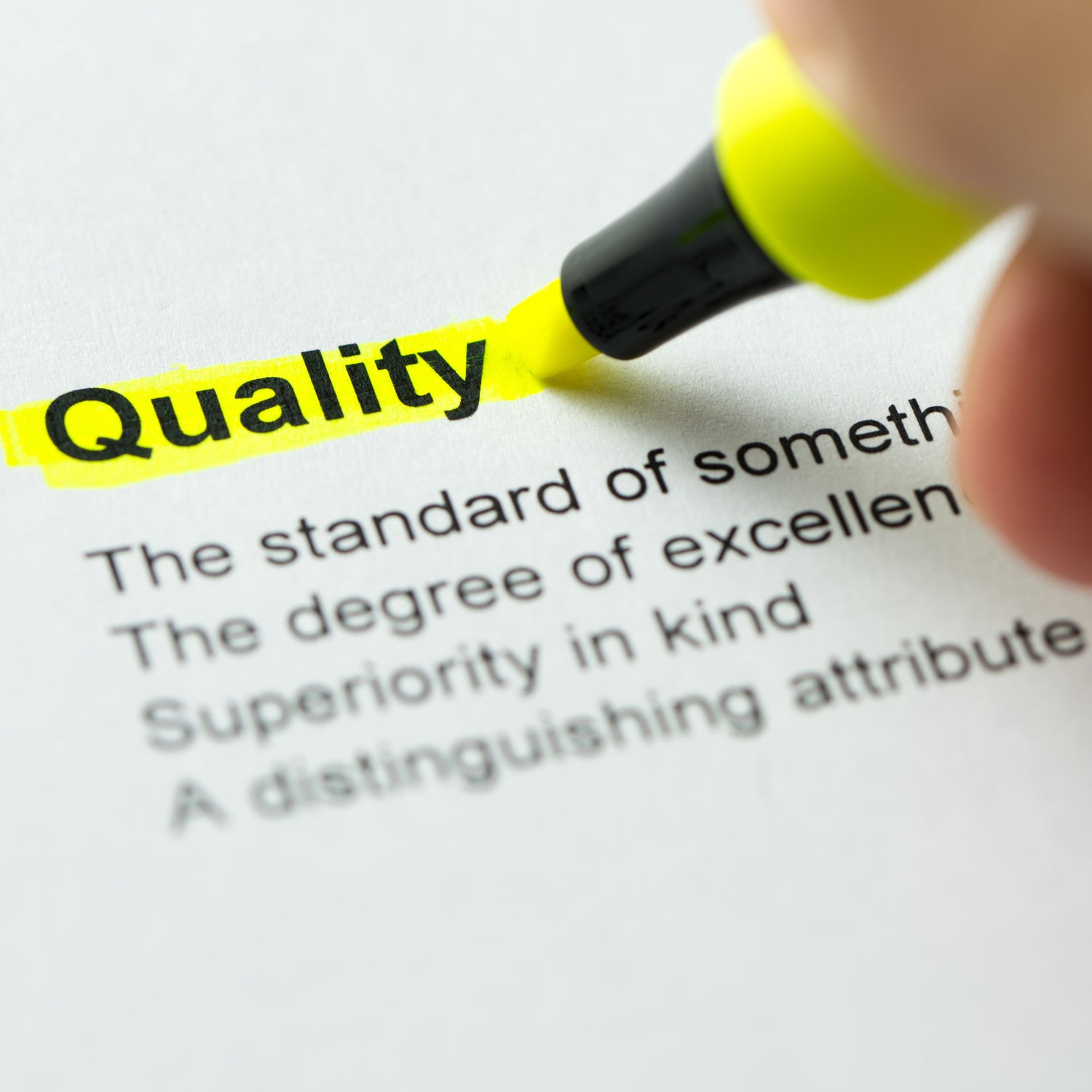 &lt;Hand with a yellow marker pen highlighting the word Quality typed on paper with the dictionary definition of quality following it. Credit&gt; AdobeStock_188314057