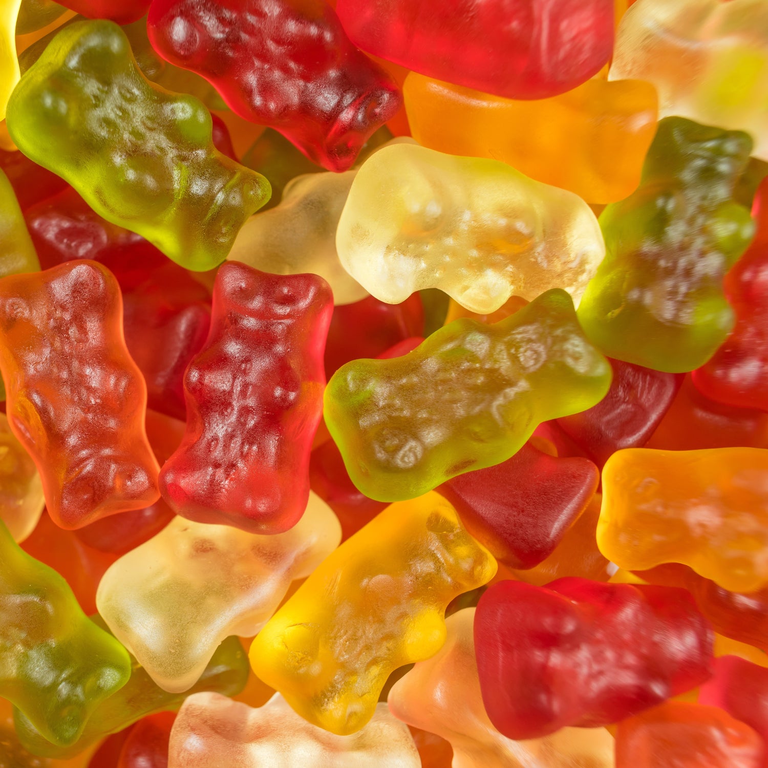 &lt;Close up view of red, yellow, and green dietary supplement gummy bears after being poured out of a mould in manufacturing. Credit&gt; AdobeStock_199784980