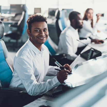 &lt;Two male and one female employees sat at desks in a customer service call centre taking complaints and customer orders by phone. Credit&gt; AdobeStock_243123859