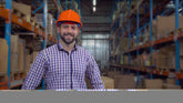 <Warehouse Manager wearing a hard hat standing in the warehouse.
Credit:> AdobeStock_277436381