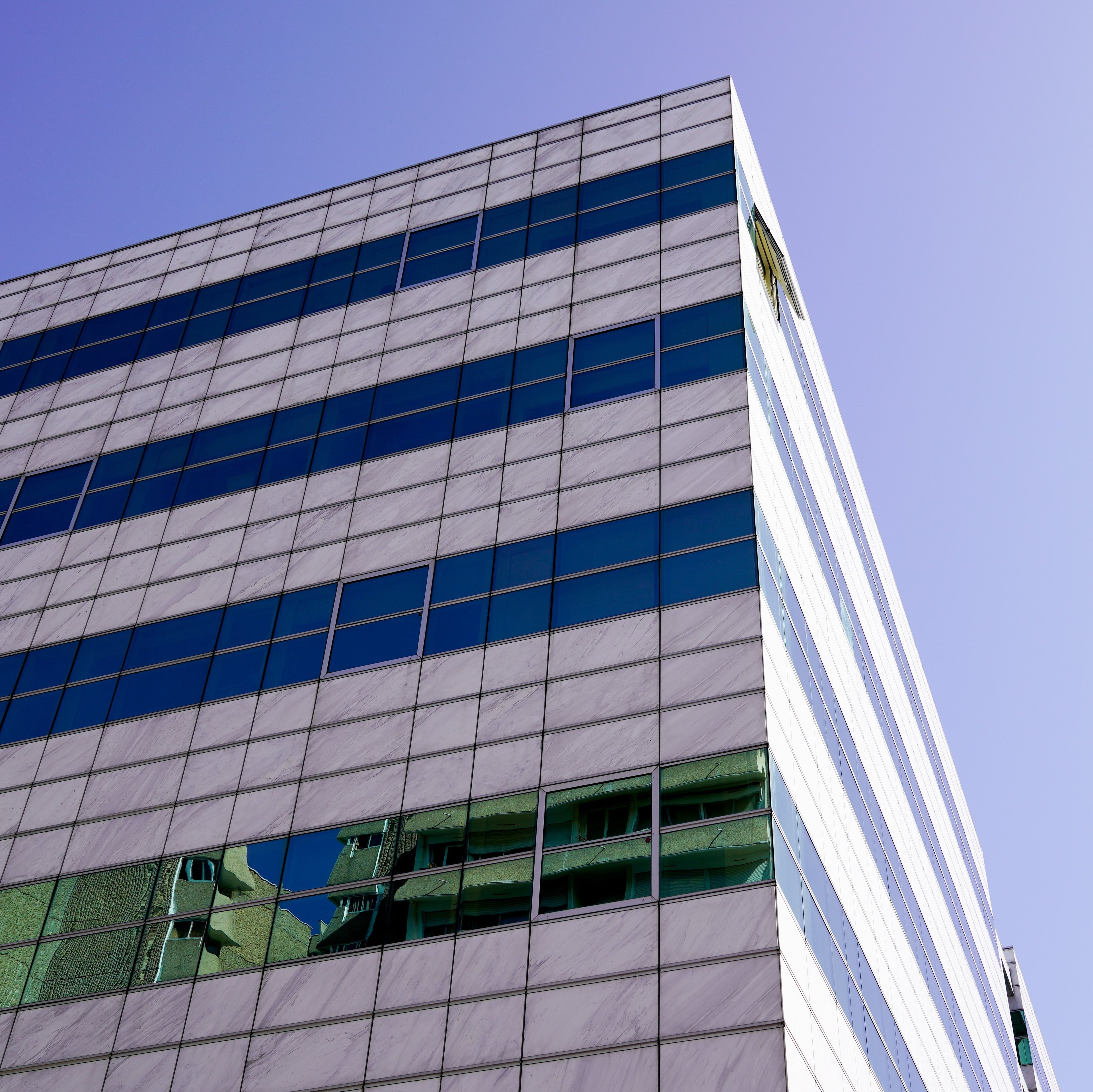 &lt;Outside corner  of a modern silver, blue and glass striped laboratory building on a bright sunny day. Credit&gt; AdobeStock_291035917