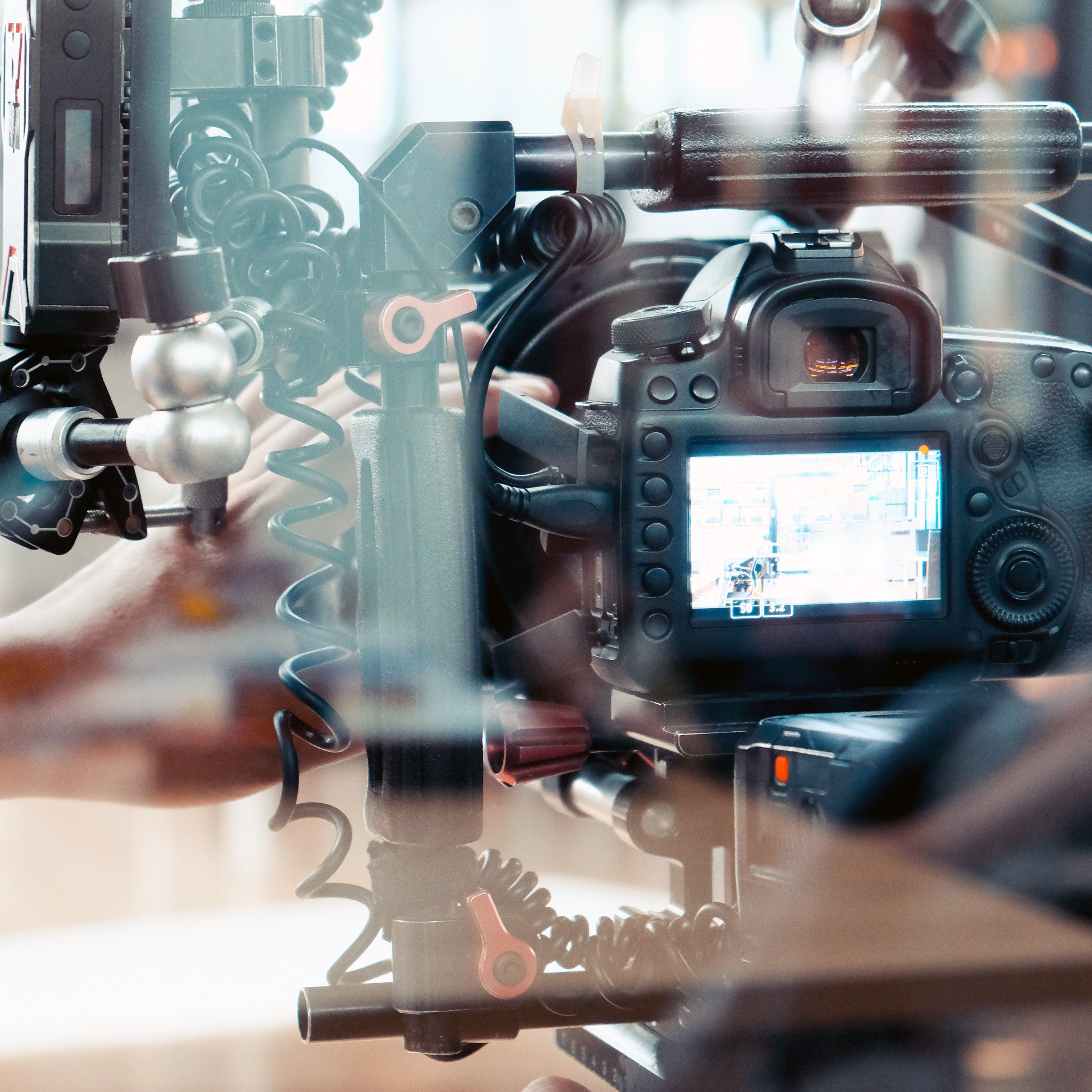 &lt;A video camera in production behind a perspex screen recording the performance of a filling line and how rejects may occur. Credit&gt; AdobeStock_302586687