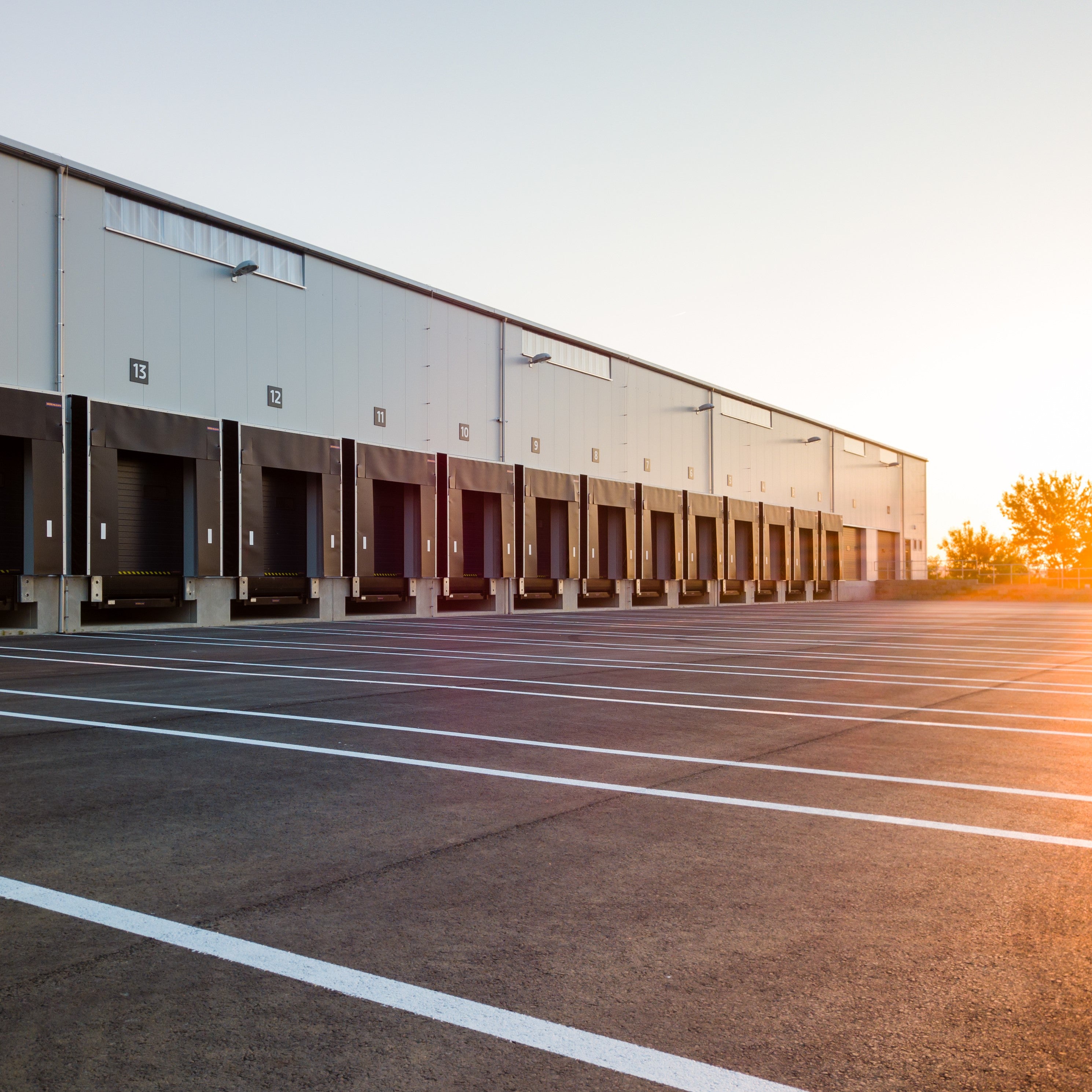 &lt;Tarmac yard of a dietary supplement distribution centre which has 20 painted lanes and entry doors for container lorries. Credit&gt; AdobeStock_315006586