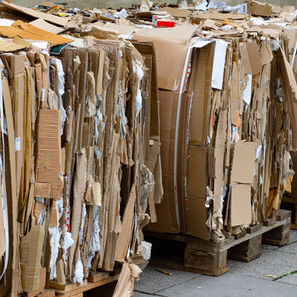 &lt;Unprinted cardboard waste from transporting packaging components bundled tightly together on several wooden pallets for recycling. Credit&gt; AdobeStock_386749997