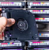 <Old records on magnetic tape storage kept in boxes with barcode numbers. Credit> AdobeStock_386856509