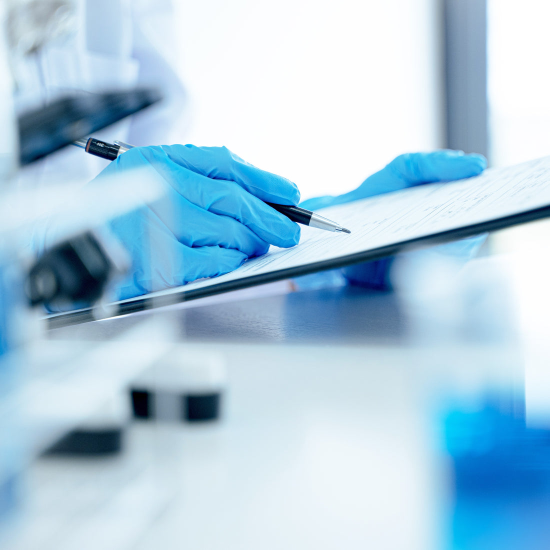 &lt;Laboratory analyst wearing blue gloves conducting an OOS investigation by completing a phase 1 form. Credit&gt; AdobeStock_391585993