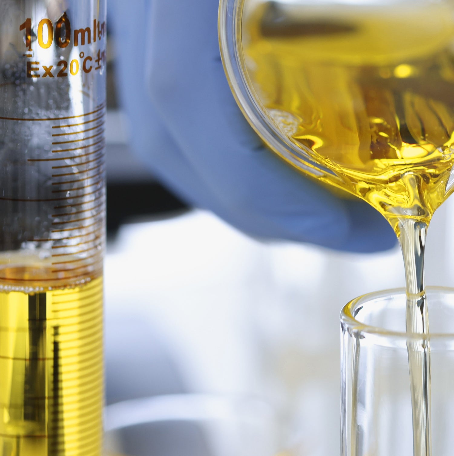 &lt;Close up of analytical grade laboratory glassware being used to measure out a volume of amber, clear oily liquid. Credit&gt; AdobeStock_395499068