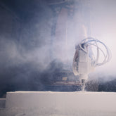 <Robotic arm cutting plastic and generating a lot of dust. Credit> AdobeStock_476222510