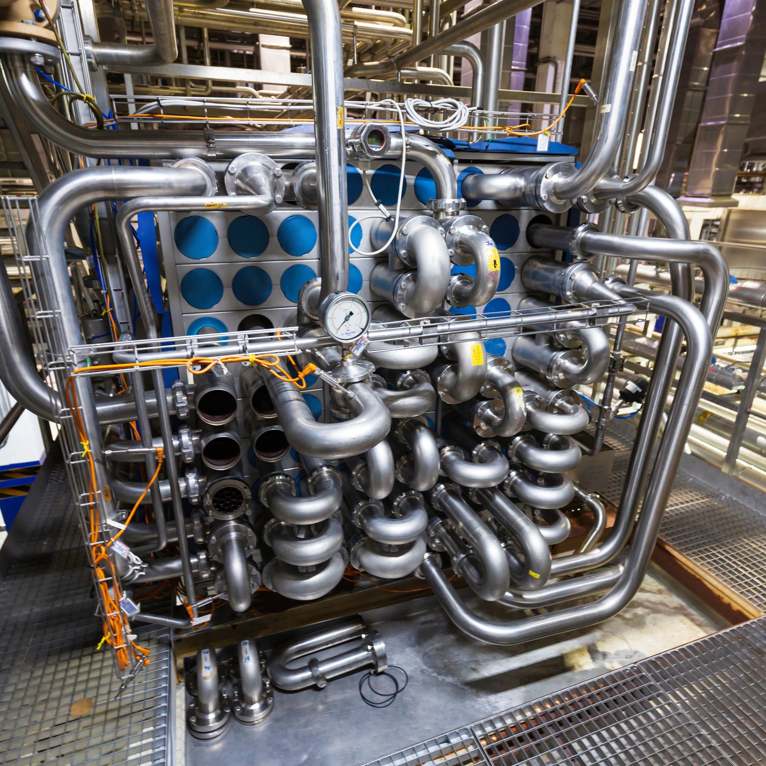 &lt;Industrial heat exchanger made up of coils of stainless steel pipes in a cube with pressure gauge for fast heating purified water for a drug manufacturing area. Credit&gt; AdobeStock_527336253