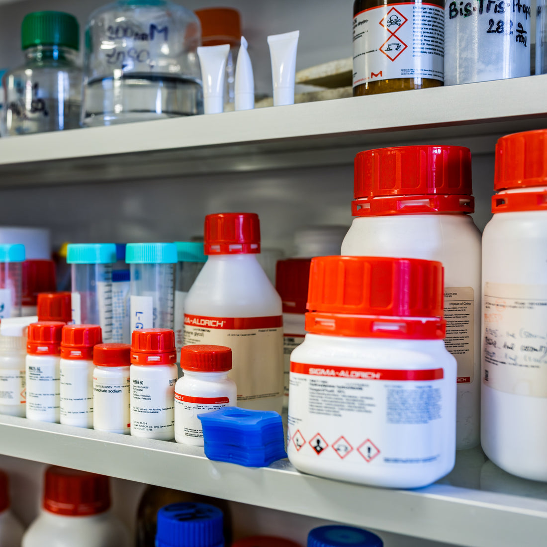 &lt;Shelves of laboratory reagents, mainly in red and white bottles from Sigma Aldrich, being inspected for adequate control of. Credit&gt; 346542643 © Forance | Dreamstime.com