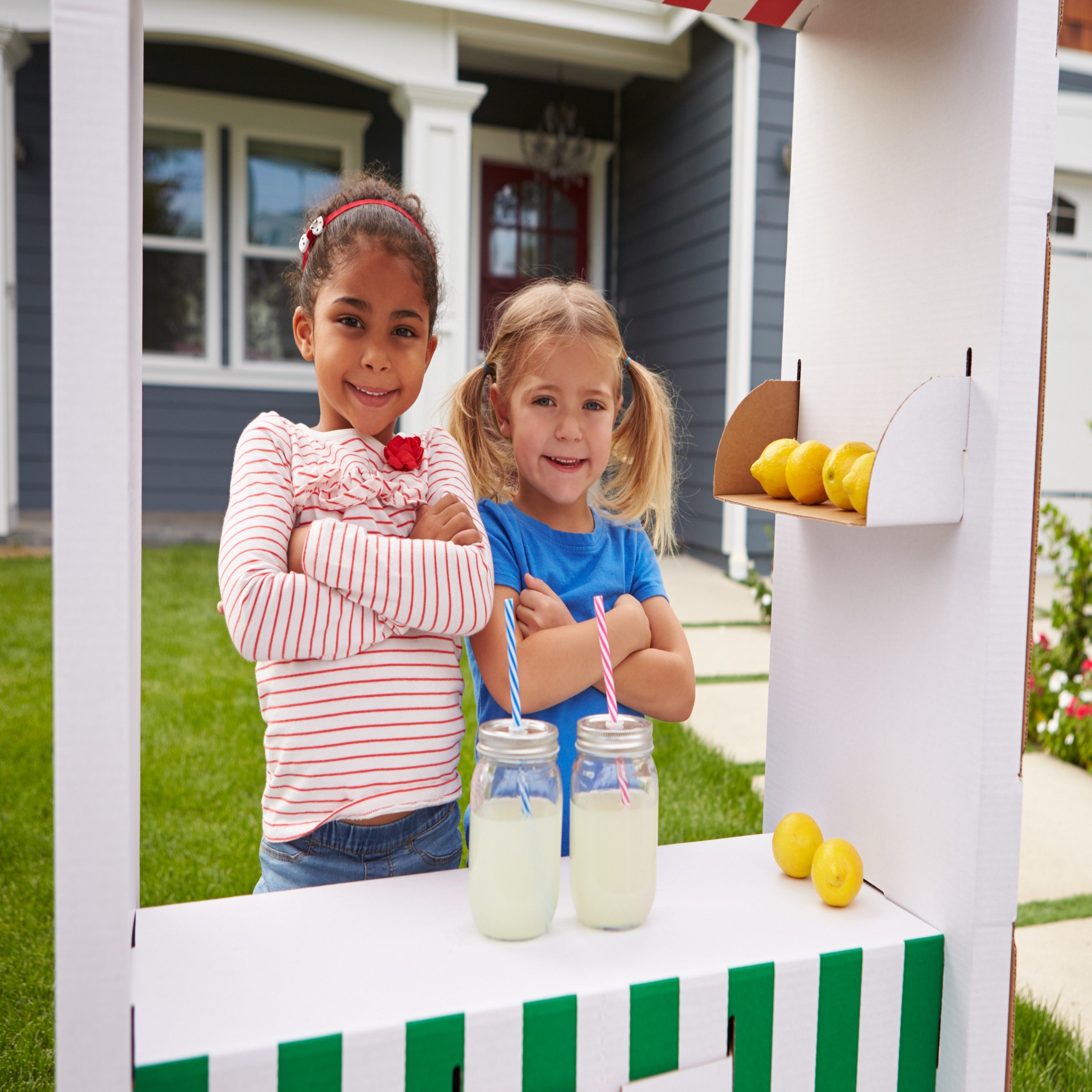 &lt;Two girls selling homemade lemonade from a booth in their front garden. Credit&gt; 71523809 © Monkey Business Images | Dreamstime.com