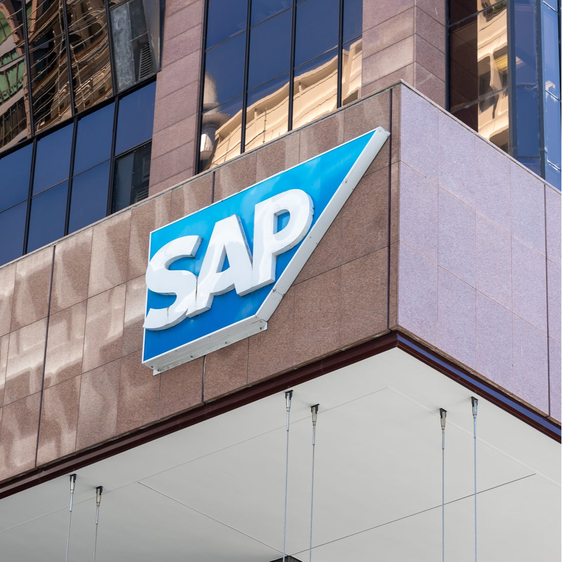 &lt;SAP company logo on one of their global headquarters of polished stone and glass, the premier exponent of supply chain management tools and records of distribution. Credit&gt; 2424408823 by JHVEPhoto @ Shutterstock